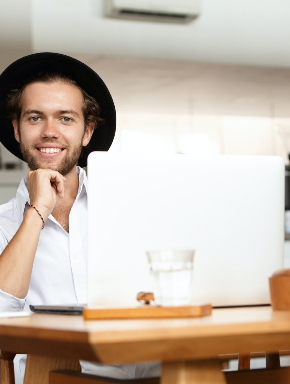 Technologies make life easier. Portrait of cheerful young man smiling joyfully, happy with his newly